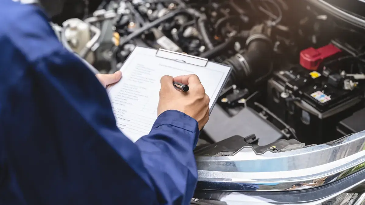 An inspector assessing a repaired vehicle
