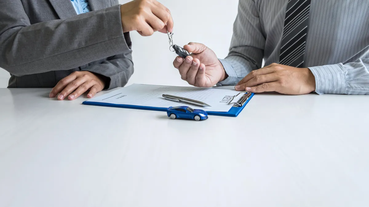 Handing over car keys after completing DMV forms