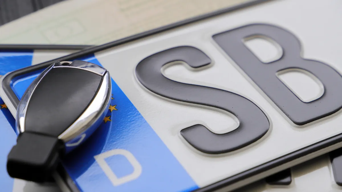 A New York licence plate resting beside a car key